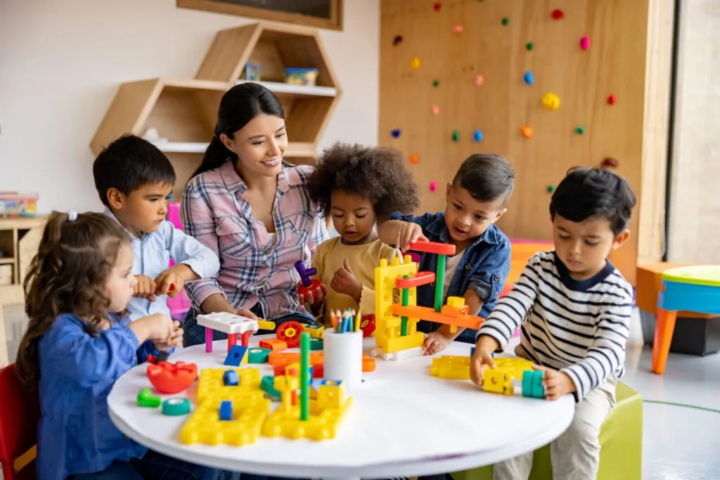 Teacher playing with toys with her young students