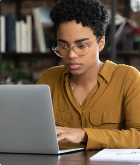 young woman at laptop in a library